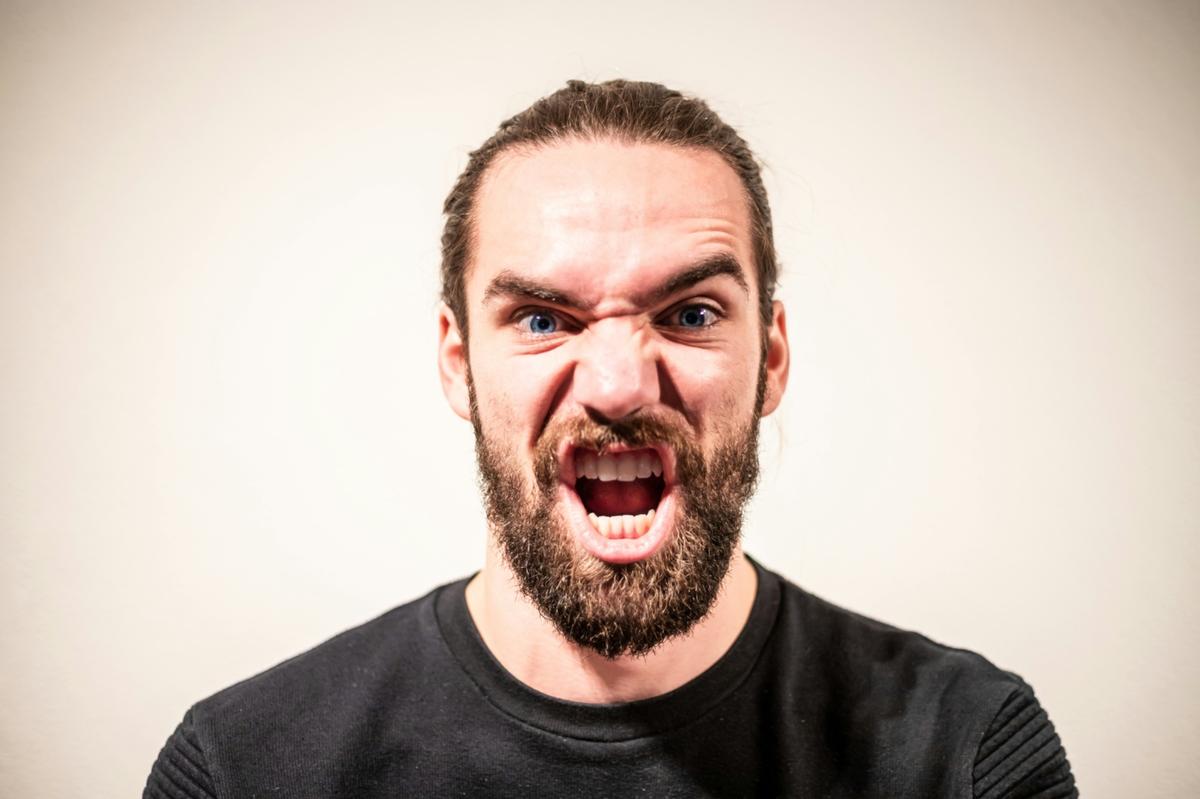 Man expressing anger and emotional intensity, representing bottled-up emotions and the psychological experience of anger explored in psychodynamic therapy.
