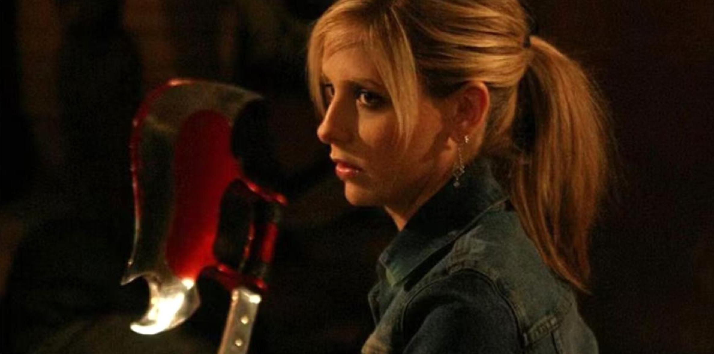 Buffy Summers from Buffy the Vampire Slayer holding a weapon in a dark scene symbolising the psychodynamic theme of confronting inner demons